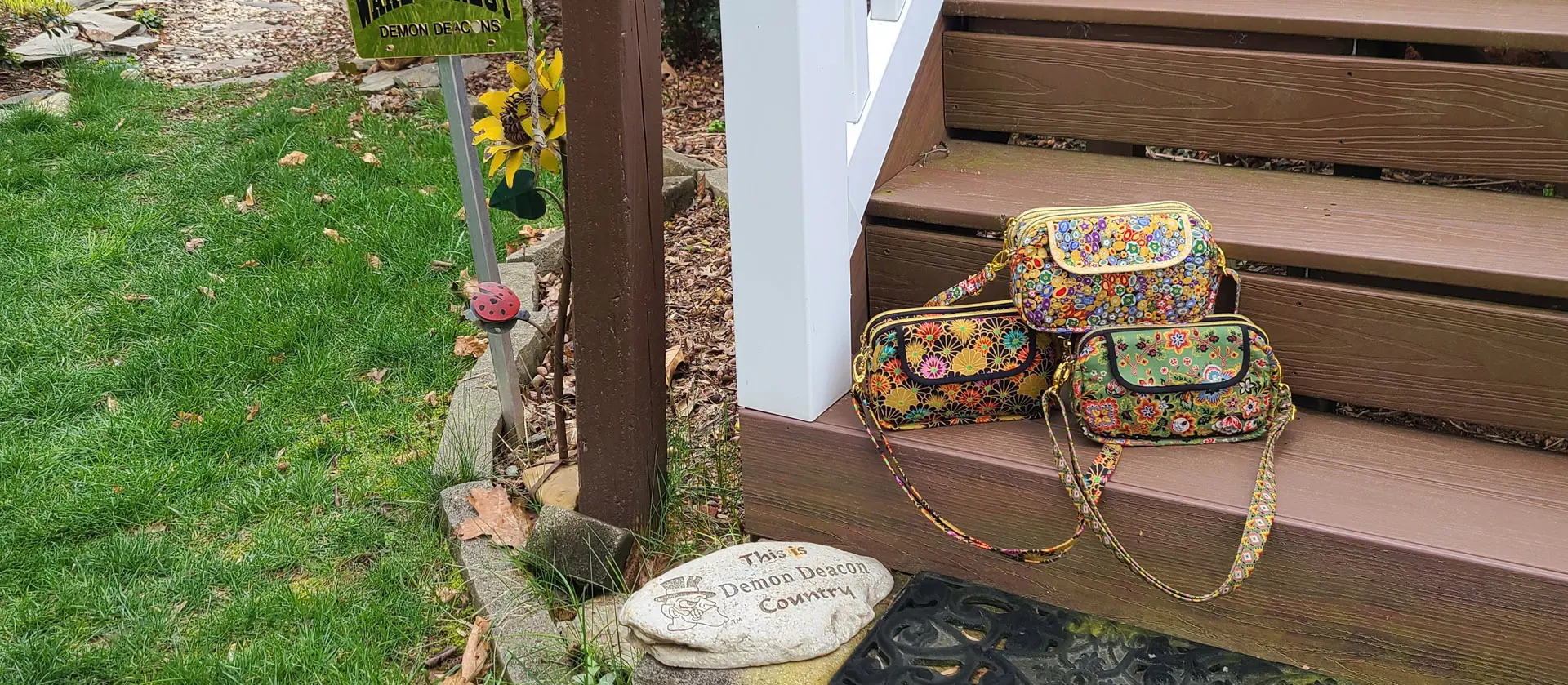 Two backpacks sitting on the steps of a house.