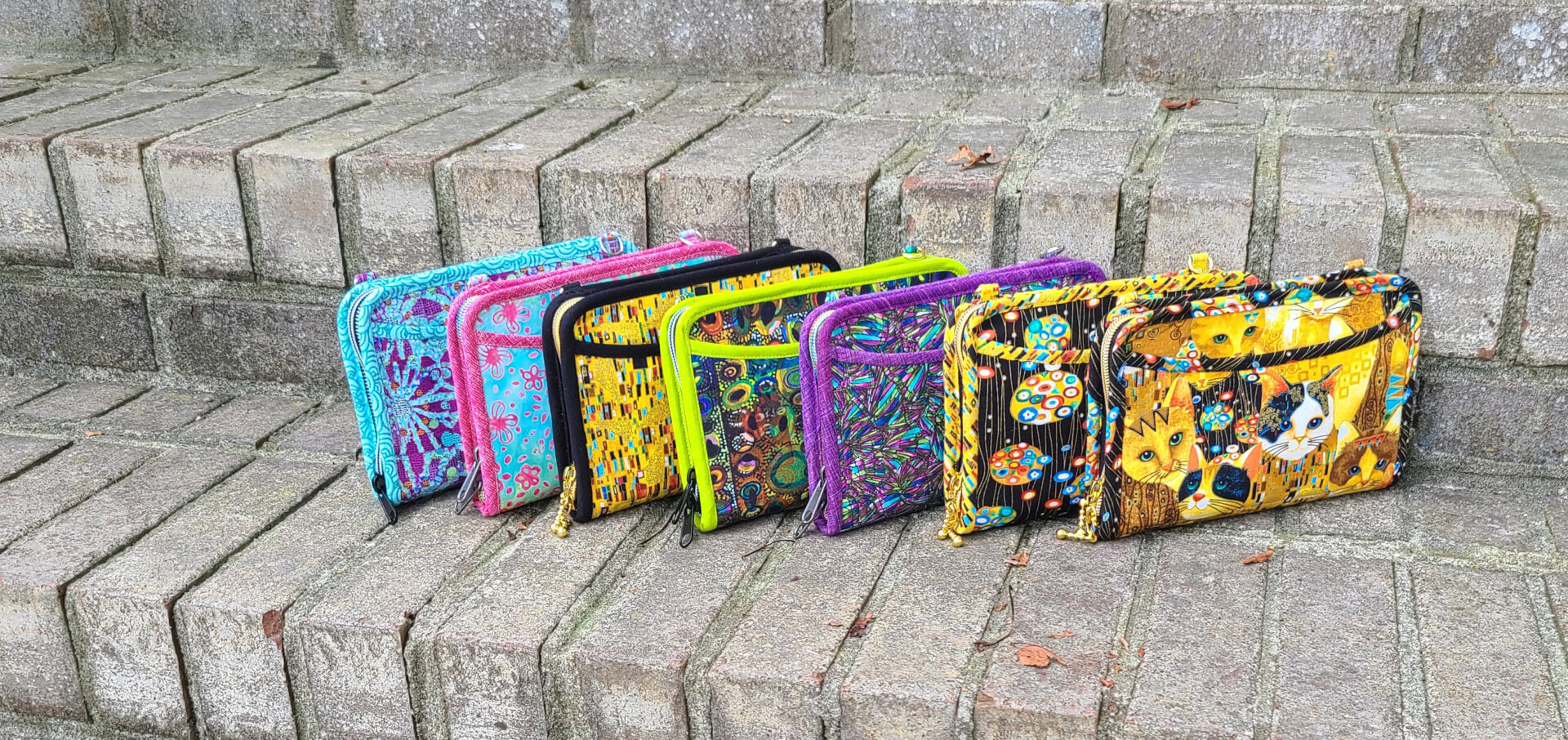 A group of colorful purses sitting on a set of steps.