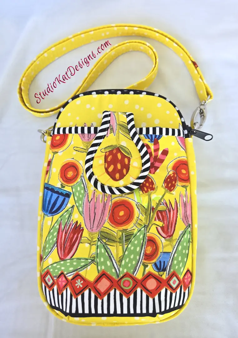 smppc33happy3 A yellow purse with flowers and stripes on it.