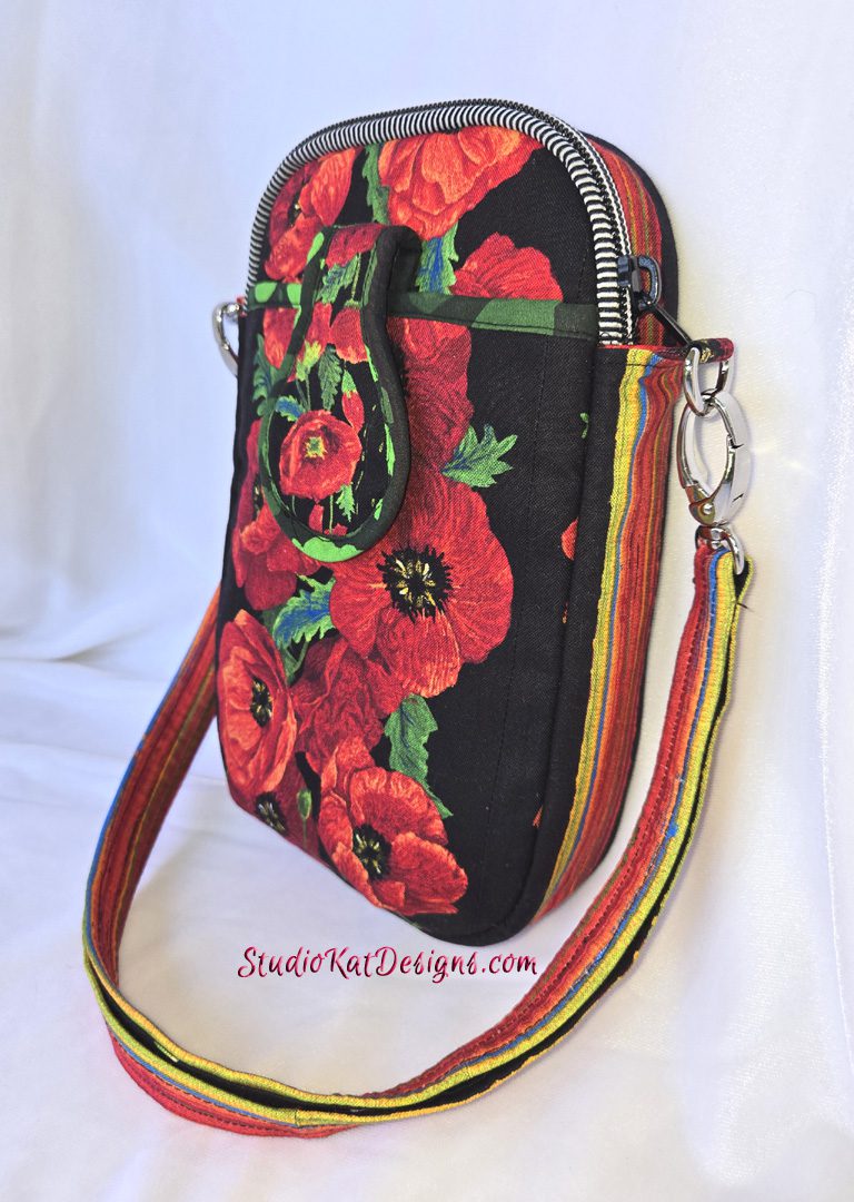 A red and black purse with flowers on it