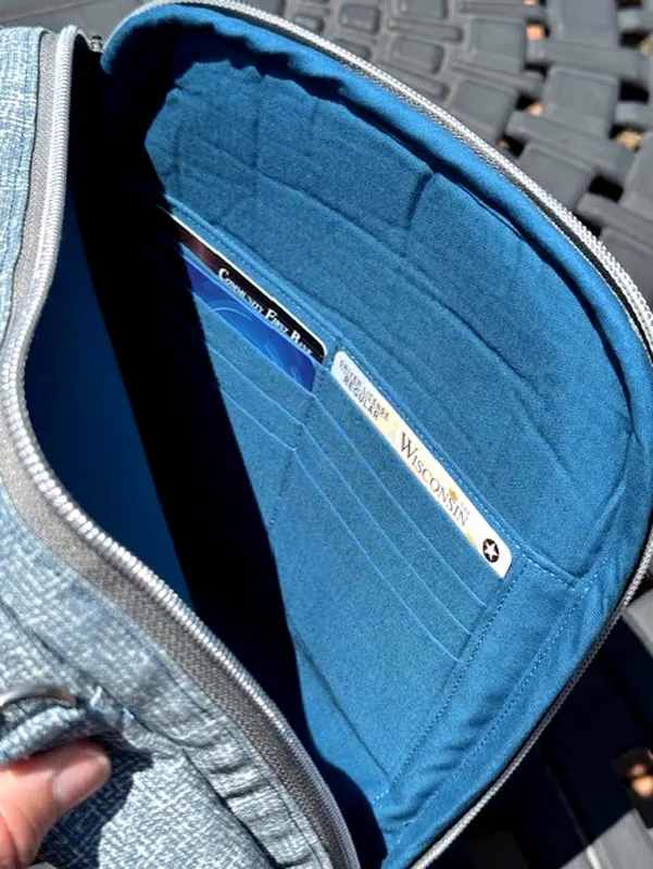 Close-up of a blue wallet's interior with card slots and compartments.