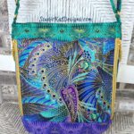 A blue and purple purse called The Guardian with a paisley pattern.