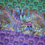 A purple, blue and green fabric with a pattern of The Guardian peacocks.