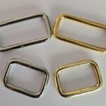 A group of four metal rings sitting on top of a table.