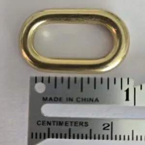 A metal ring is shown next to a ruler.