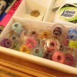 a box of threads and other sewing tools