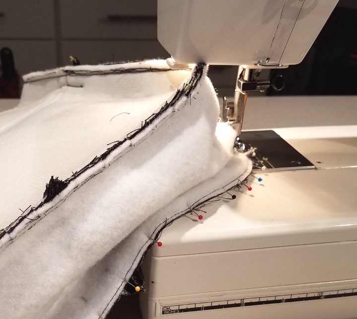 An ongoing sewing of a white bag