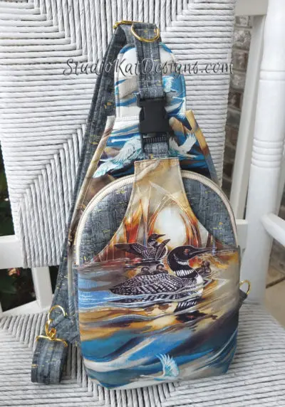 A sling bag with black and white swan design