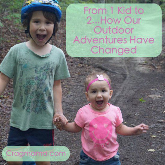 A boy wearing a green top and a toddler wearing a pink shirt