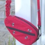 closeup of a Studio Kat Designs Red Sling Bag