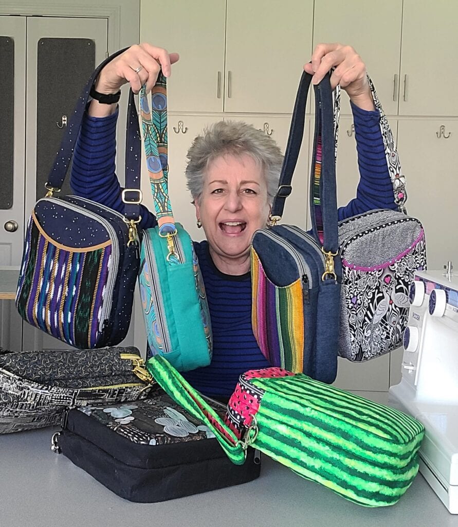 A woman holding four bags
