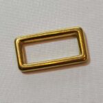 A square brass ring on a white surface.