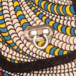 A close up of an african print purse with a ring on it.