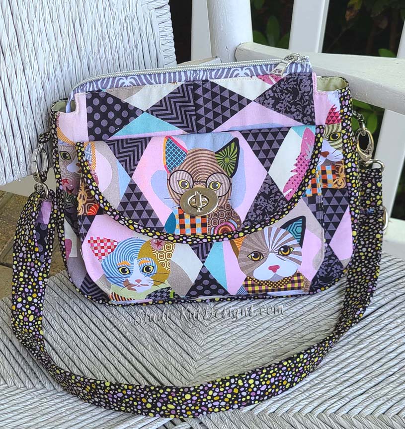 A quilted bag with cats on it.