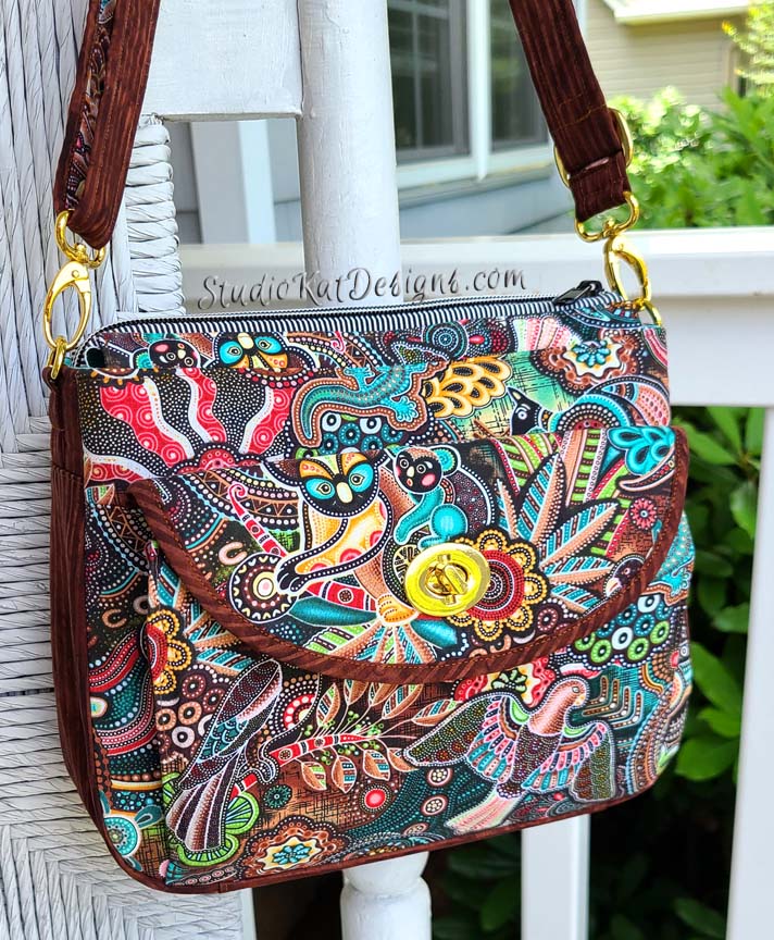 A colorful handbag hanging on a porch.