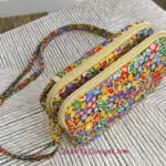 A purse with a colorful flower print on it.