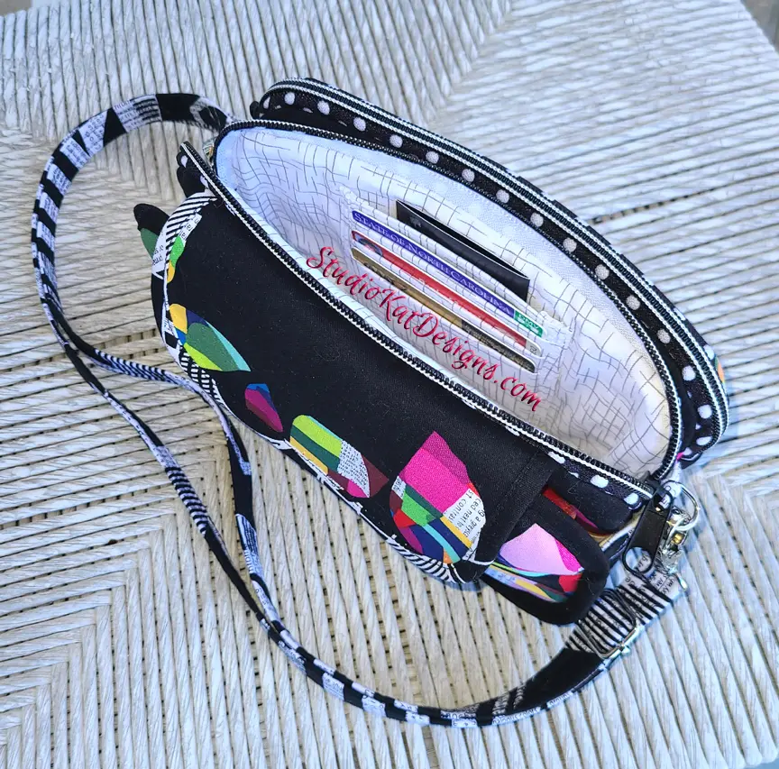 A black purse with a colorful pattern on it.