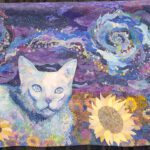 A quilt with a cat and sunflowers on it.
