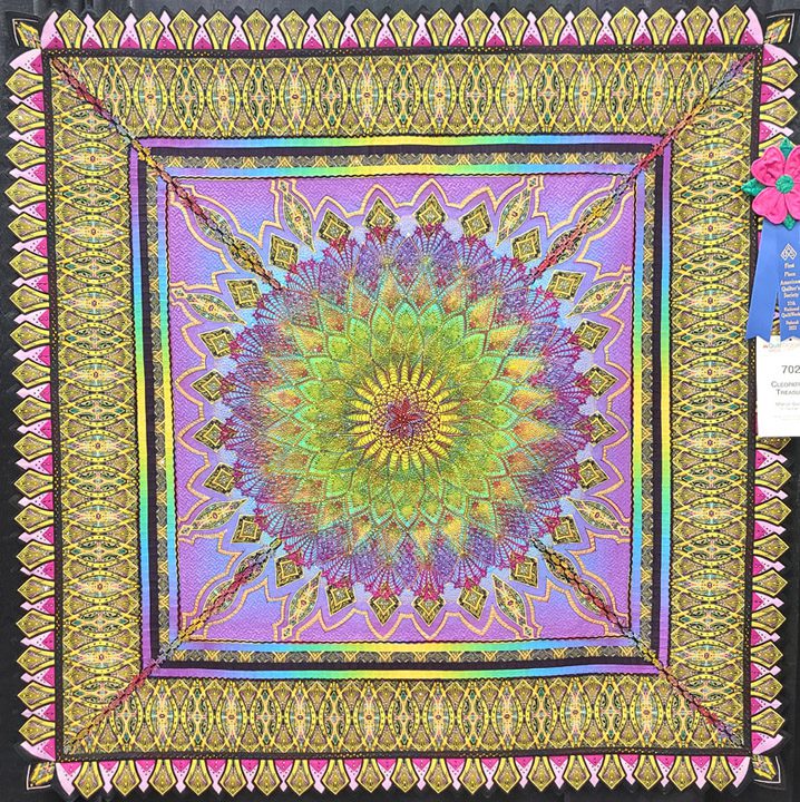 A quilt with a colorful design on it.