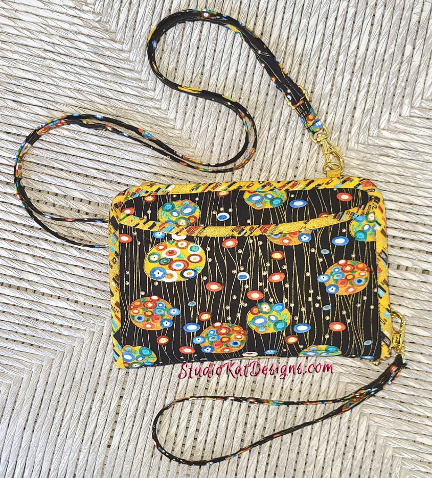 A black purse with colorful flowers on it.