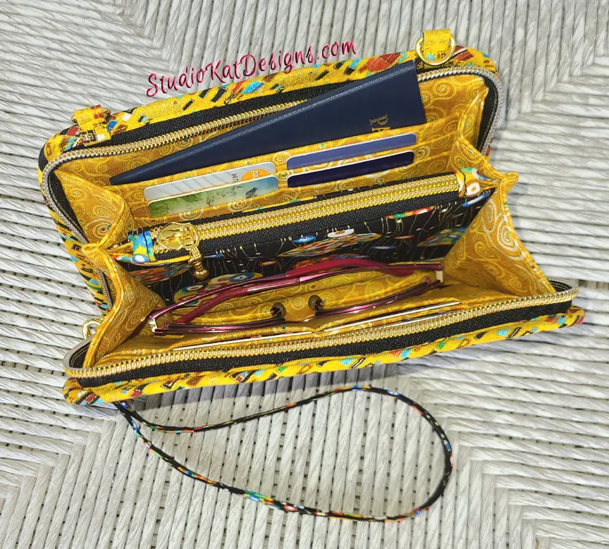 A yellow wallet with a key ring attached to it.