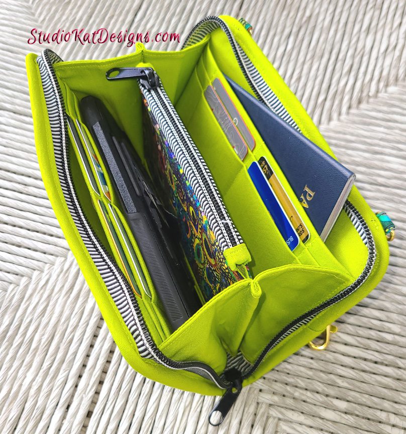A green zippered bag with several items inside.