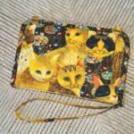 A purse with cats on it.