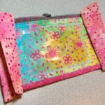 A pink and blue ID Holder (in vinyl) sold in pairs with polka dots on it.
