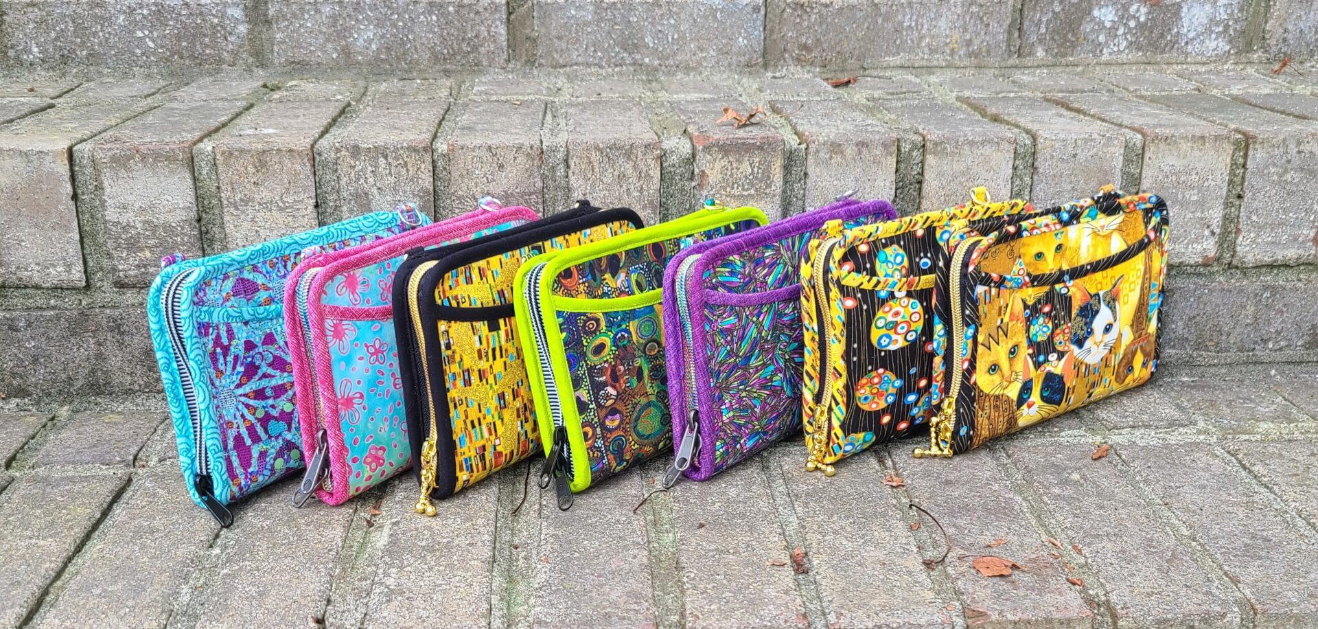A group of colorful purses sitting on steps.