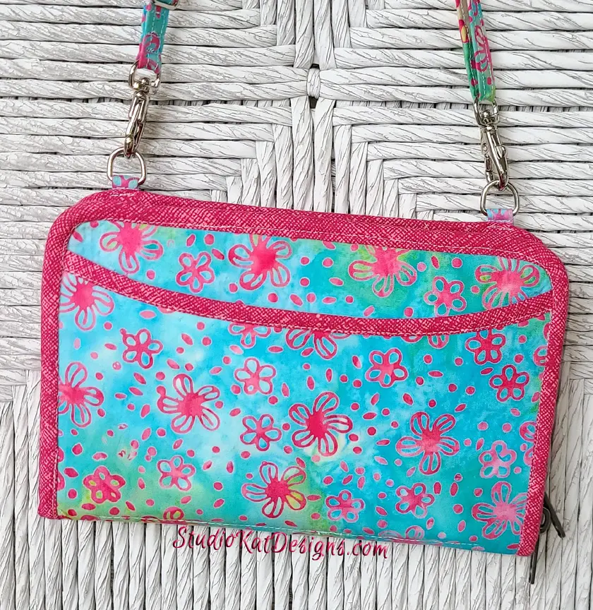 A purse with a pink and blue floral pattern.