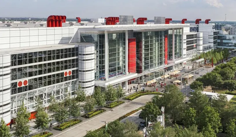 An aerial view of a large building with red and white awnings.