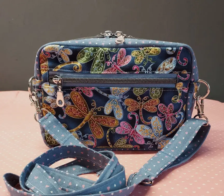 A purse with butterflies on it and polka dots.