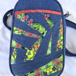 A blue bag with a colorful design on it. A blue bag with a colorful design on it.