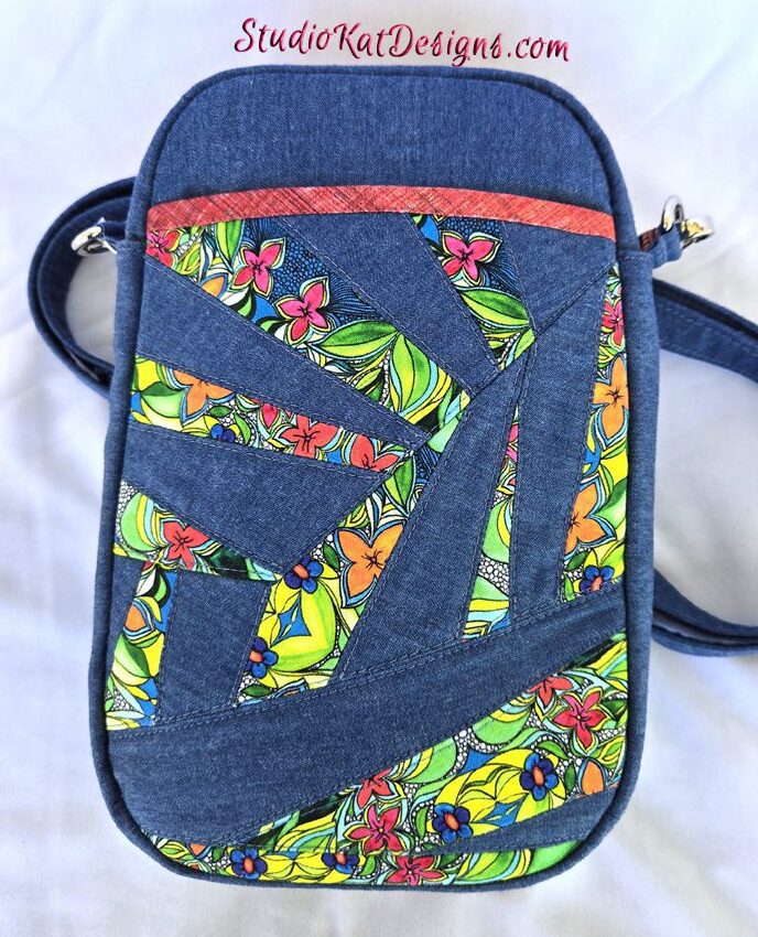 A blue bag with a colorful design on it.