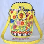 A yellow purse with strawberries and flowers on it. A yellow purse with strawberries and flowers on it.
