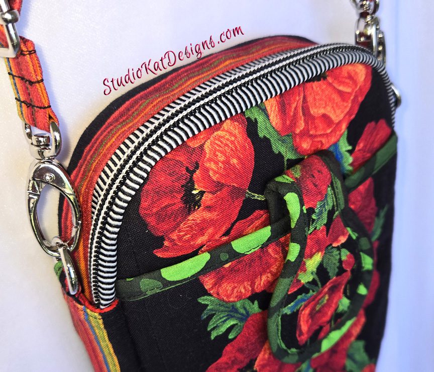 A close up of the shoulder bag with red flowers