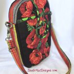 smppc33poppiesSide3 A red floral purse with a black background