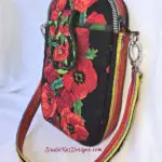 A red and black purse with flowers on it A red and black purse with flowers on it