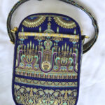 Intricately embroidered traditional bag with gold and blue patterns. Intricately embroidered traditional bag with gold and blue patterns.