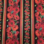 Red poppy flowers with green leaves on black and red striped fabric.