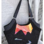 Black handbag with colorful abstract design and sturdy handles. Black handbag with colorful abstract design and sturdy handles.