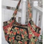 Floral-patterned tote bag with orange and green leaves design. Floral-patterned tote bag with orange and green leaves design.