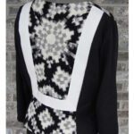 Black and white long-sleeve top with a geometric pattern on the back. Black and white long-sleeve top with a geometric pattern on the back.