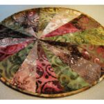Colorful round fabric patchwork with intricate patterns. Colorful round fabric patchwork with intricate patterns.