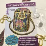 Vintage Cignet Phone Pod with floral design and chain handle, including clips and attachments.