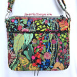 Colorful floral and butterfly patterned crossbody bag with multiple zippers.