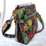 Colorful floral crossbody bag with vibrant patterns and a sturdy strap.