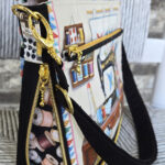 Decorative sailboat model with black straps and intricate paint details.