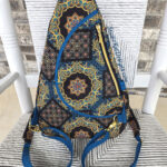 Blue patterned sling backpack with mandala design
