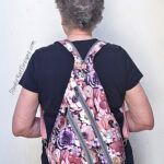 Person wearing pink floral backpack with zippers